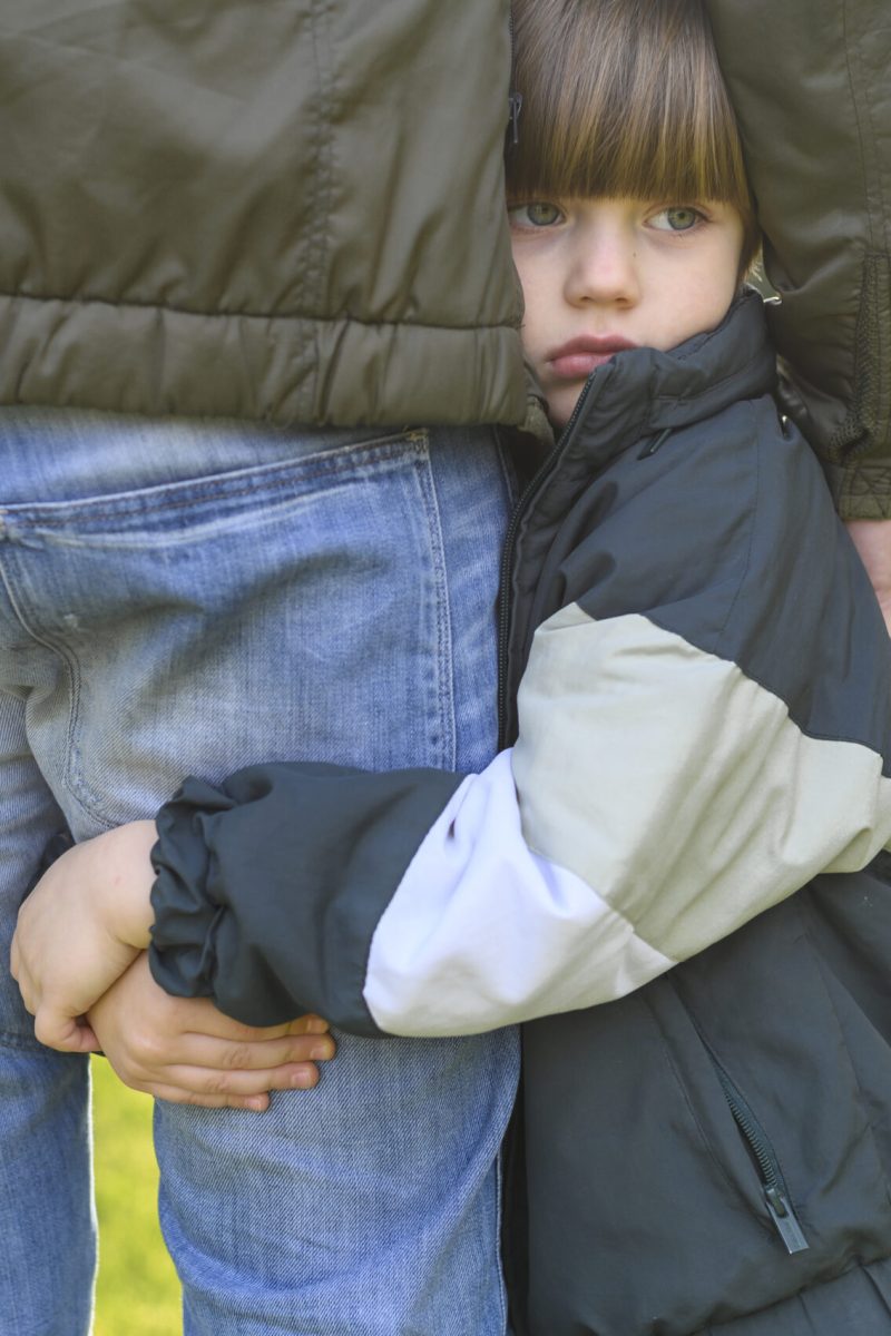 close-up-kid-holding-adult-s-leg